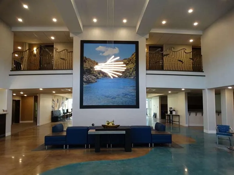 Two-story Best Western Plus lobby with a large canyon photograph on the feature wall