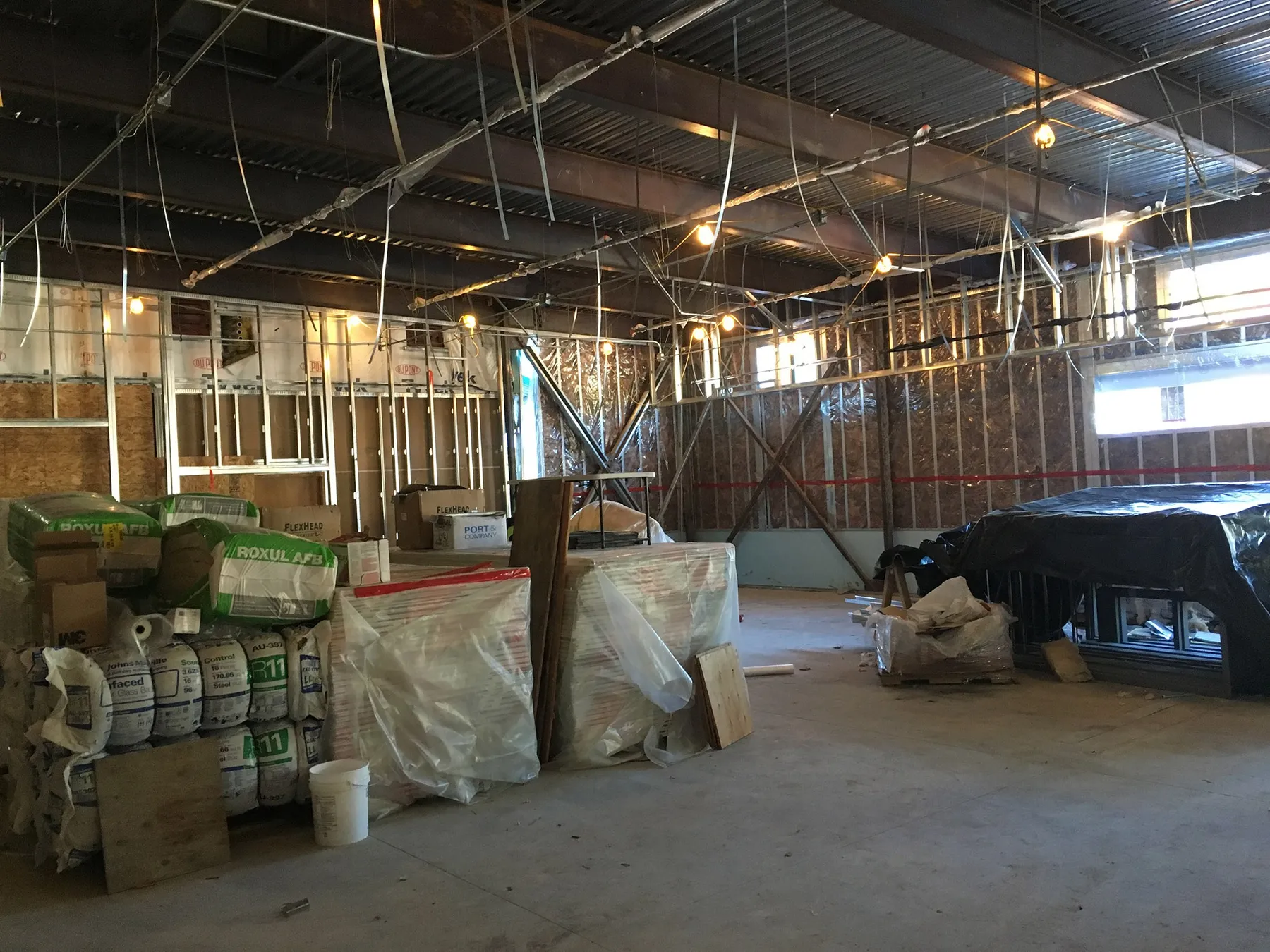 Klahowya school interior during construction with framing and stacked materials