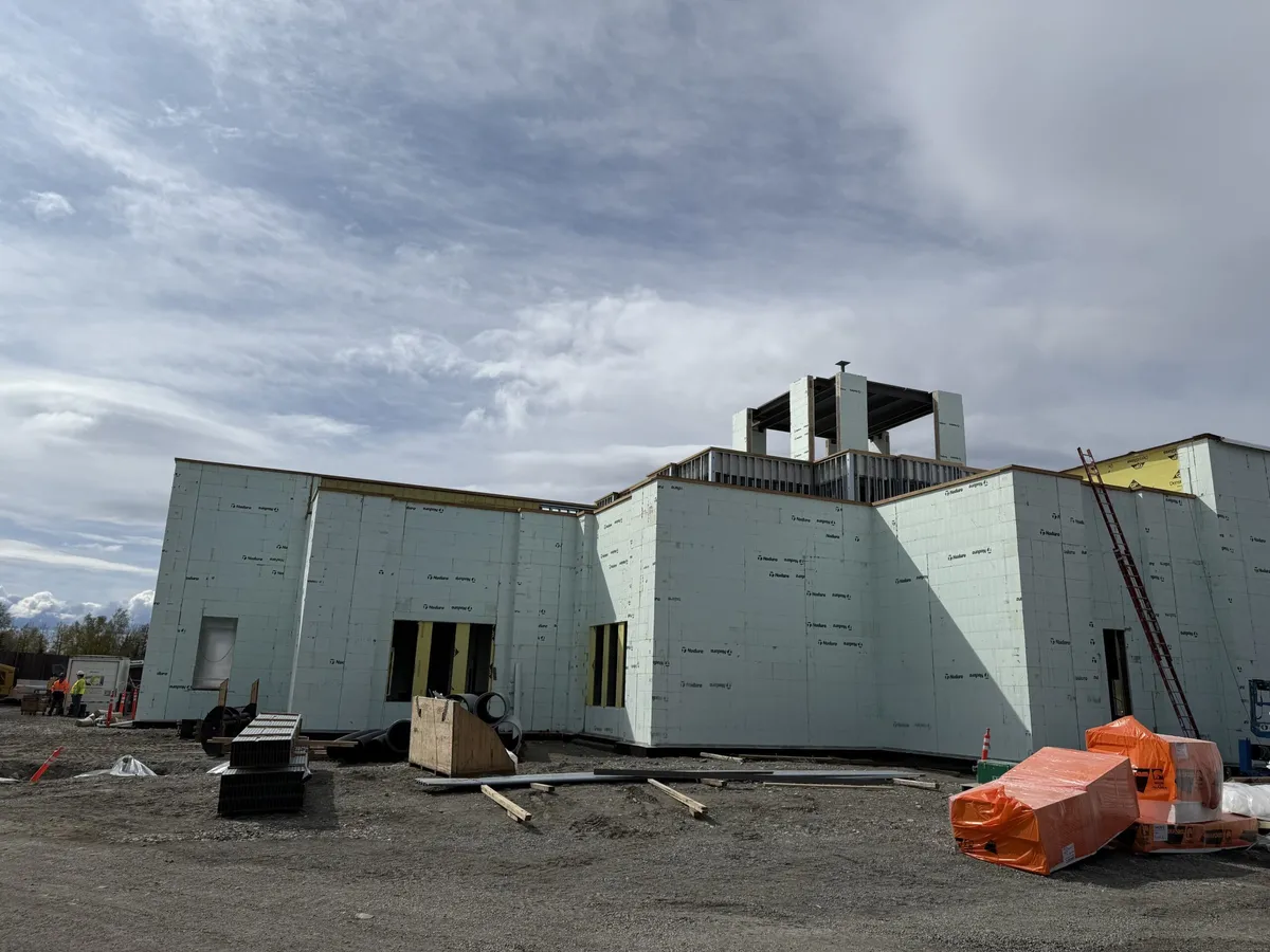 Side of the LDS church temple under construction with materials staged on site